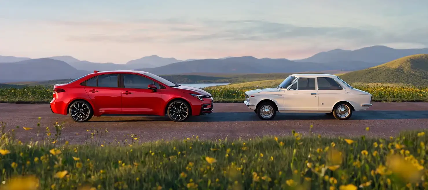 Corolla Hybrid 60th Anniversary shown in Supersonic Red and 1966 Corolla in Aphrodite White, Credit:Toyota